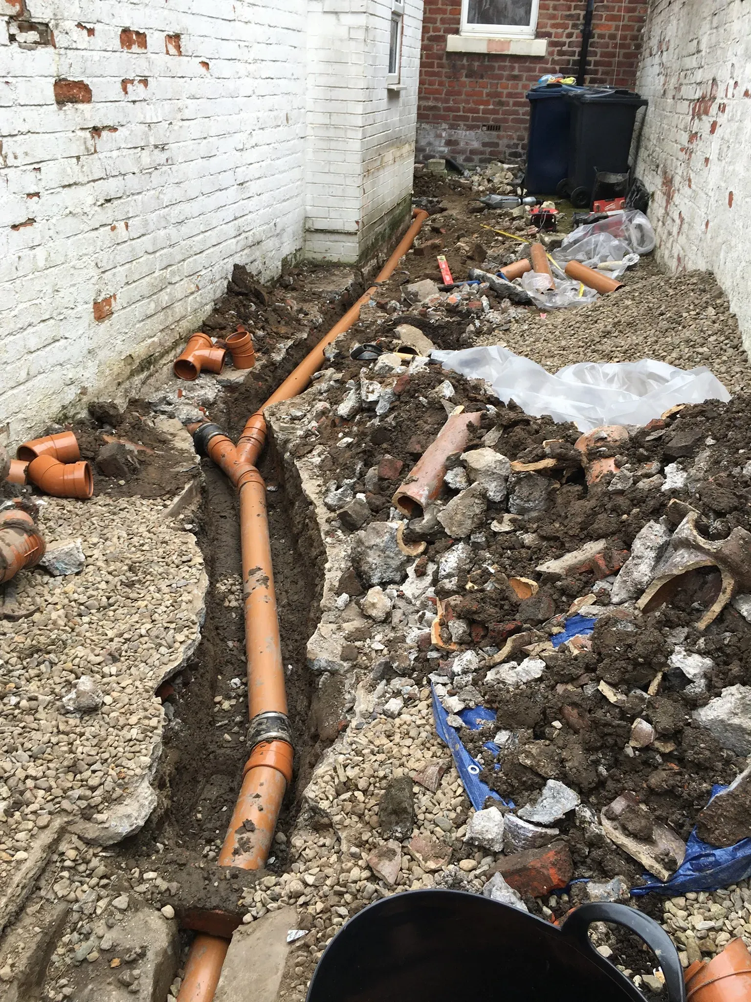 New drainage pipes installed in an excavated trench