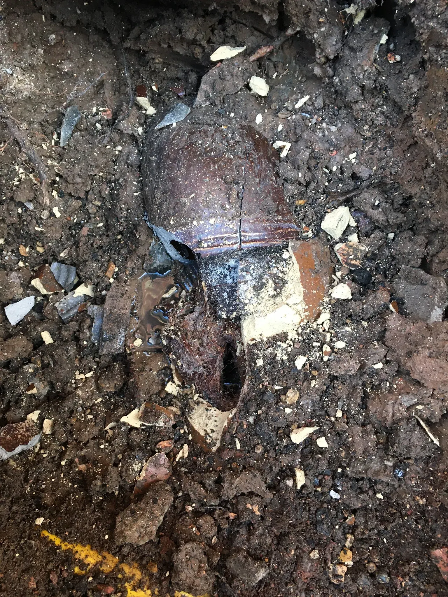 Close-up of a broken or collapsed underground drain pipe requiring repair.