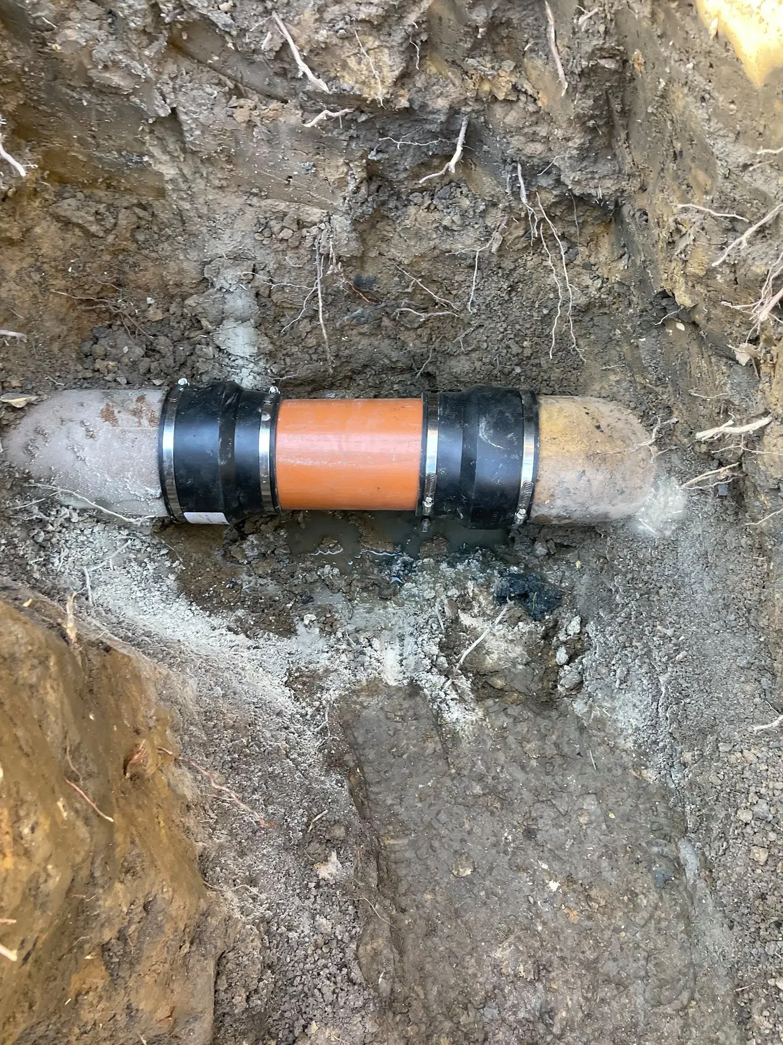 Repaired drainage pipe section connected securely with couplings